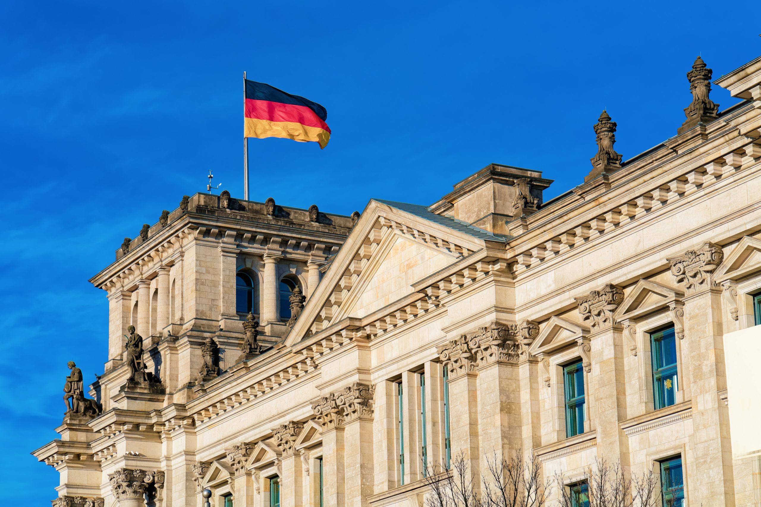 Reichstag building architecture with German Flag in Berlin city center, capital of Germany in winter in the street. German Bundestag parliament house.